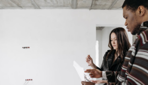 The construction team reviewing plans on-site with disconnected workflows leading to coordination gaps and project errors