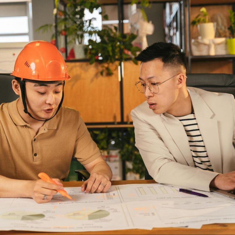 Construction teams reviewing project data to prevent costly decision conflicts